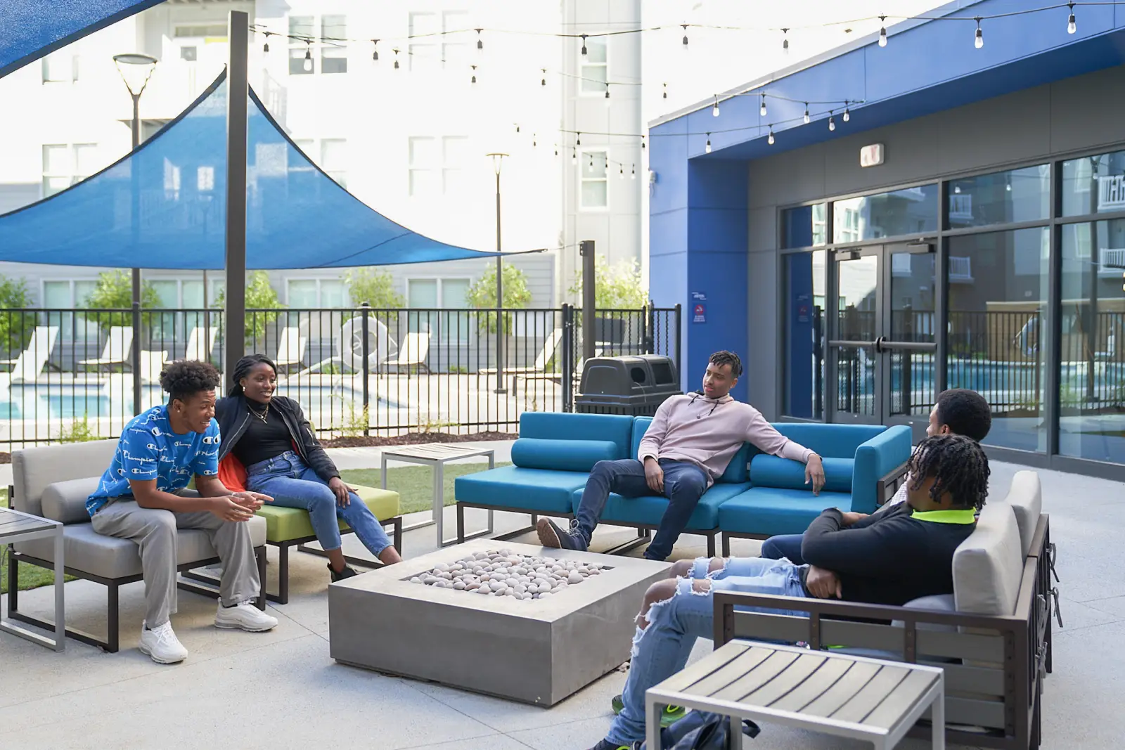 outdoor lounge friends at firepit kennesaw state student apartments
